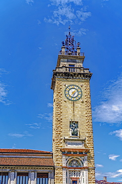 Day view of Torre dei Caduti with clock, 1924 historic stone Tower of The Fallen, at Piazza Vittorio Veneto, Bergamo, Lombardy, Italy, Europe