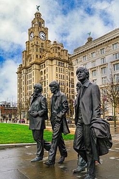 The Beatles statue, bronze art depicting the famous band facing river Mersey with Royal Liver Building in the background, Liverpool, Merseyside, England, United Kingdom, Europe