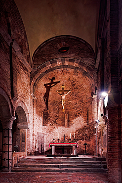 Statue of Jesus hanging on the cross with shadow on the walls of Santo Stefano complex buildings, part of Sette Chiese (The Seven Churches, Bologna, Emilia Romagna, Italy, Europe