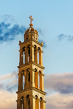 St. George Holy Orthodox Metropolitan Church bell tower and cross against a sky with clouds in Nafplion, Peloponnese, Greece, Europe