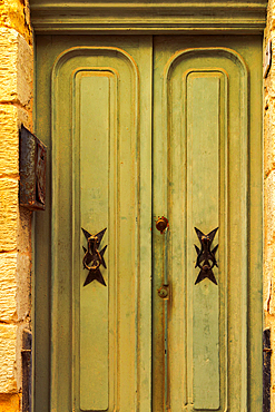 Traditional brass door knockers with Maltese cross design outside a building in the alleys of the old city of Birgu (Citta Vittoriosa), Malta, Mediterranean, Europe