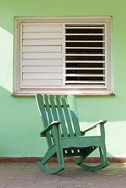 Green rocking chair on veranda, UNESCO World Heritage Site, Vinales, Pinar del Rio, Cuba, West Indies, Caribbean, Central America