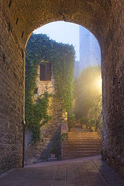 A misty dawn view of a street in San Gimignano, UNESCO World Heritage Site, Tuscany, Italy, Europe