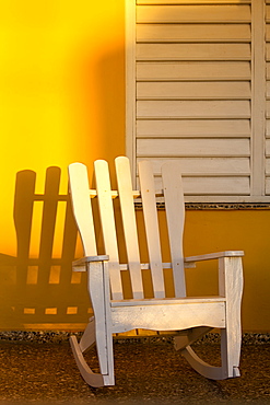 White rocking chair on yellow porch, Vinales, UNESCO World Heritage Site, Cuba, West Indies, Caribbean, Central America