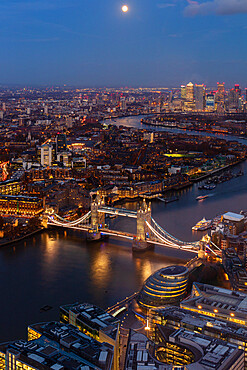 River Thames, Tower Bridge and Canary Wharf from above at dusk with moon, London, England, United Kingdom, Europe