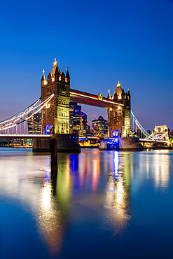 Tower Bridge and The City of London skyscrapers reflecting in River Thames at sunset, London, England, United Kingdom, Europe