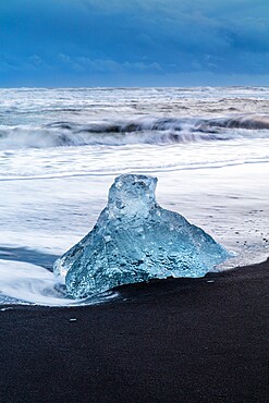 Iceberg from melting glacier on black sand beach near Jokulsarlon glacier lagoon, Vatnajokull National Park, Iceland, Polar Regions