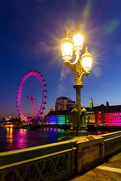 Lamp on Westminster Bridge with London Eye and London Aquarium in background at sunrise, London, England, United Kingdom, Europe