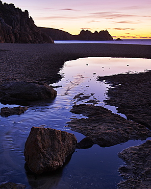 Early morning on the beach looking out towards Logan Rock at Porthcurno, Cornwall, England, United Kingdom, Europe