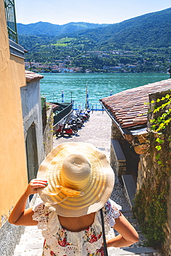 Woman with hat on Monte Isola, the largest lake island in Europe, Province of Brescia, Lombardy, Italy, Europe