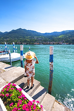 Woman admiring the Iseo Lake seen from Monte Isola, the largest lake island in Europe, Province of Brescia, Lombardy, Italy, Europe