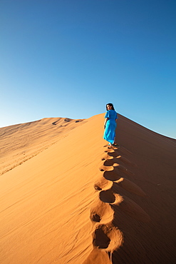 Model climbing Dune 13, Sossusvlei, Namibia, Africa