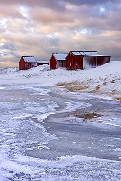 Fresh snow surrounds typical fishermen houses called Rorbu in winter, Eggum, Lofoten Islands, Arctic, Norway, Europe