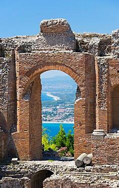 View from the Greek Theatre through arch to the Bay of Naxos, Taormina, Messina, Sicily, Italy, Mediterranean, Europe