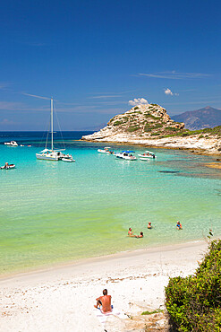 Tourists relaxing in shallow turquoise water off the Plage du Petit Loto, St-Florent, Haute-Corse, Corsica, France, Mediterranean, Europe