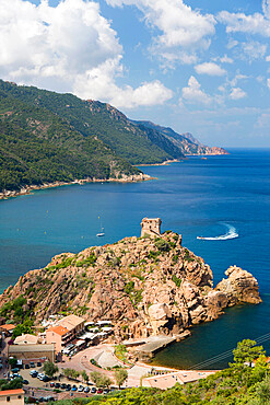 View over the village and coast from hillside, Genoese watchtower prominent on headland, Porto, Corse-du-Sud, Corsica, France, Mediterranean, Europe