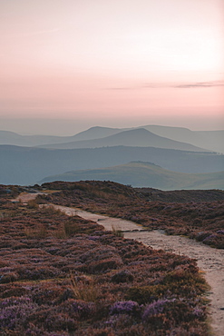 A path in the Peak District National Park leading towards the mountains in the background with a lovely pink sky, Peak District, Derbyshire, England, United Kingdom, Europe