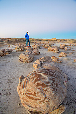 Exploring the cracked egg sandstone formations of Bisti/De-Na-Zin Wilderness at sunset, New Mexico, United States of America, North America