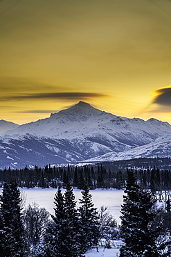 Sunrise over the frozen Otto Lake and snowy mountains of Denali National Park in the background, Alaska, United States of America, North America