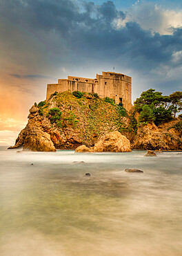 The 16th century Lovrjenac Fortress at sunset with a long exposure ocean foreground, Dubrovnik, Croatia, Europe