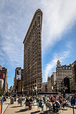 People gather at the Flatiron Building to drink coffee and take in the sun, Manhattan, New York, United States of America, North America