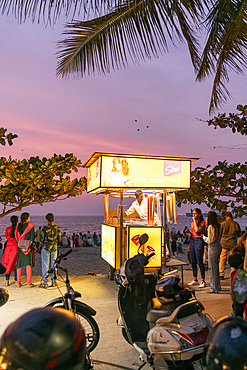 Ice cream vendor on the beach at sunset, Fort Kochi, Kerala, India