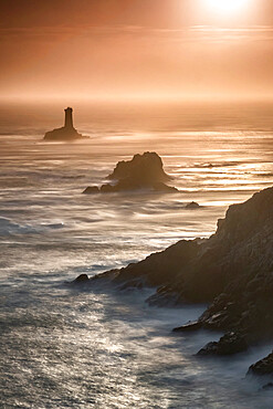 Pointe du Raz lighthouse and cliffs at sunset in Finisterre, Brittany, France, Europe