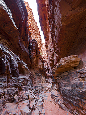 A narrow rocky red canyon in Wadi Rum desert in Jordan