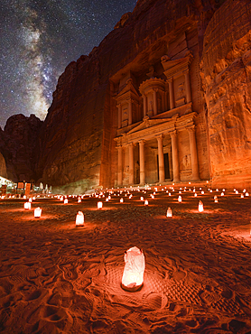 Petra Treasury (El Khazneh) by night illuminated by small lanterns and the Milky Way in the sky, Petra, UNESCO World Heritage Site, Jordan, Middle East