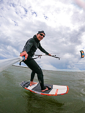 Photographer Skip Brown on his foiling kiteboard on the Pamlico Sound, Nags Head, North Carolina, United States of America, North America