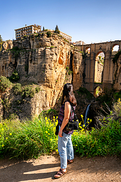 Woman looking at historic bridge of Ronda, Pueblos Blancos, Andalusia, Spain, Europe