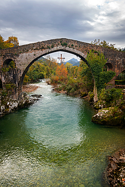 Cangas de Onis historic medieval Roman bridge over the Sella River in Picos de Europa National Park, Asturias, Spain, Europe