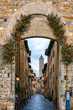 San Gimignano entrance with iconic tower and stone buildings street, San Gimignano, Tuscany, Italy, Europe