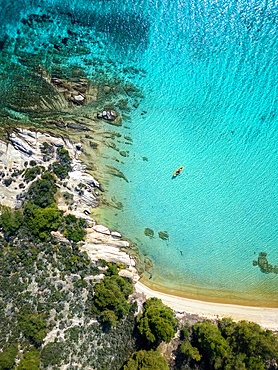 Diaporos island with wild beaches and a kayak on the turquoise water drone top aerial view in Greece