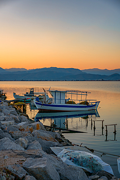 Nafplion port with fishermen boats at sunset in Greece