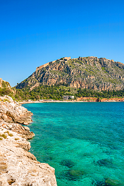 Arvanitias beach in historic city of Nafplion with Palamidi fortress on top of the mountain in Greece