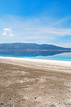 Salda lake with turquoise water and white sand and mountains at sunset in Turkey