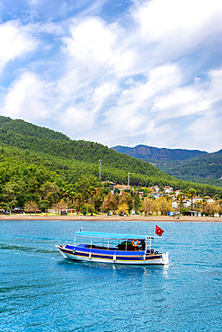 Tourist boa in the turquoise water of Ekincik in Turkey