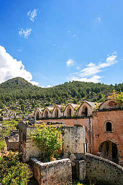 Kayakoy greek ghost town church and abandoned houses in the mountains full of vegetations in Fethiye, Turkey