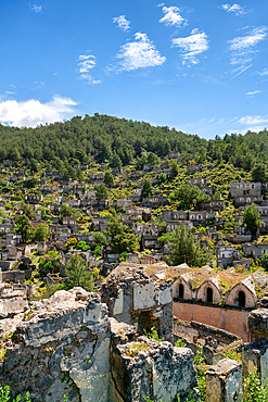 Kayakoy greek ghost town church and abandoned houses in the mountains full of vegetations in Fethiye, Turkey