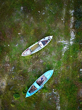 Drone aerial view of abandoned boats in Marmara dry lake now full of vegetation in Turkey at sunset