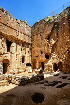 Gumusler ancient monastery with caves on the rock in Turkey