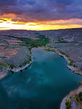 Drone aerial view of Akkoy dam lake with reflection on the water in Cappadocia at sunset, in Turkey