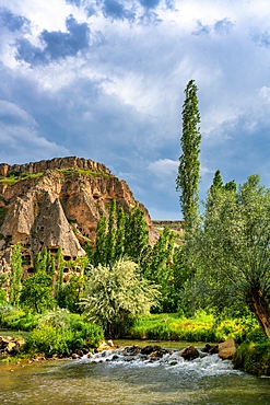 Selime houses carved on the rocks by the river on the Ihlara valley in Cappadocia, Turkey