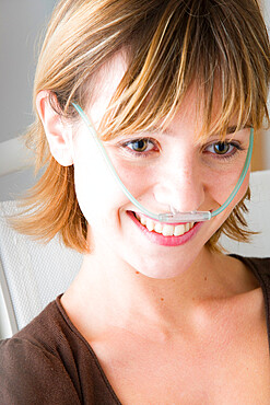 Oxygen therapy is a treatment that has the aim to bring oxygen to a person. Here, the young woman use nasal cannula.