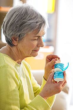 Elderly person taking medication