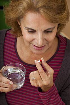 Elderly person taking medication