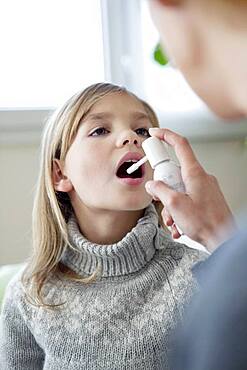 Child using spray in mouth