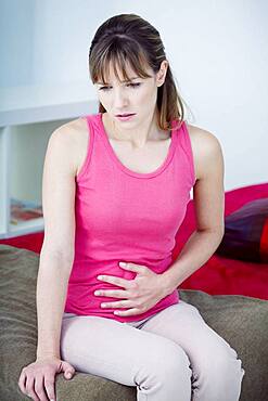 Woman suffering from abdominal pain.