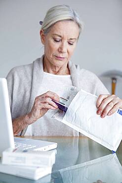 Senior woman receiving medicines bought on internet.